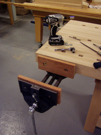 Installing the front vise's jaws.